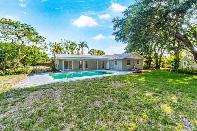 rear view of house with a yard and a patio area