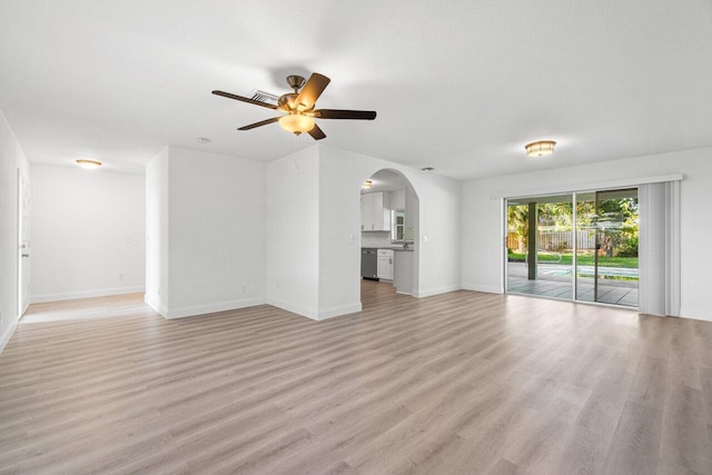 unfurnished living room with ceiling fan and light hardwood / wood-style flooring