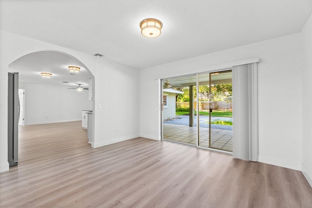 spare room featuring light wood-type flooring and ceiling fan