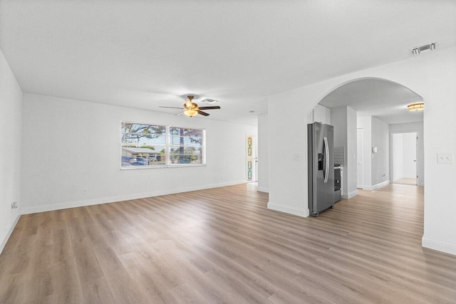 unfurnished living room featuring a textured ceiling, light hardwood / wood-style floors, and ceiling fan