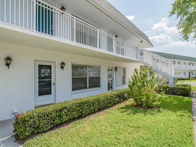 property entrance with a lawn