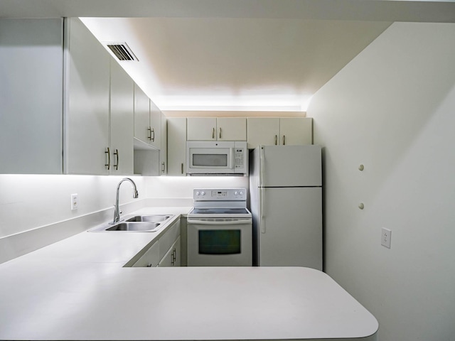 kitchen featuring white appliances and sink