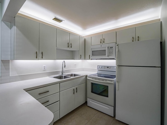 kitchen with white appliances, sink, and light tile floors