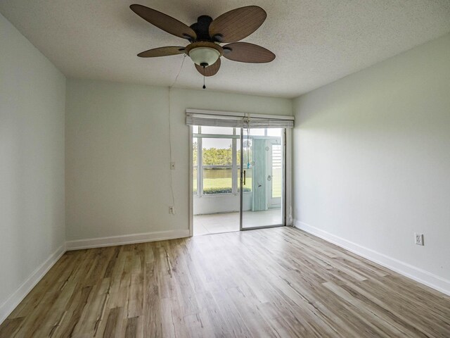 spare room with ceiling fan, a textured ceiling, and light wood-type flooring