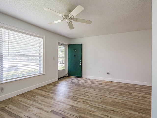 entryway featuring ceiling fan, a textured ceiling, and wood-type flooring