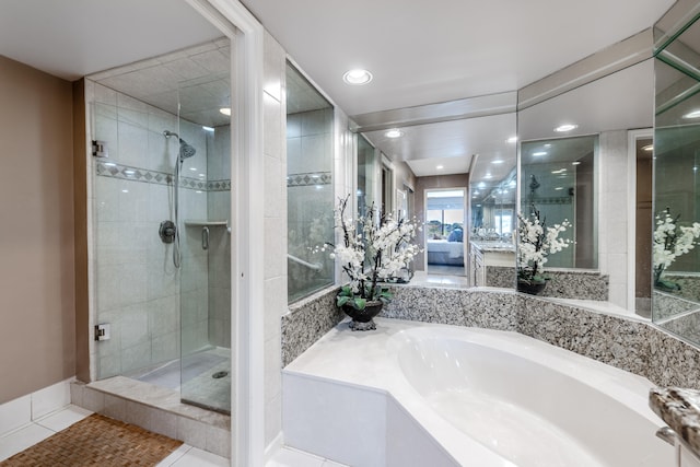 bathroom featuring shower with separate bathtub and tile patterned floors