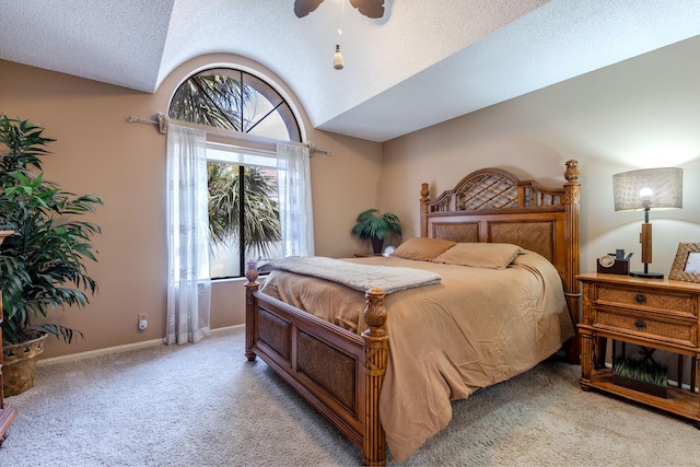 bedroom with vaulted ceiling, a textured ceiling, ceiling fan, and carpet floors