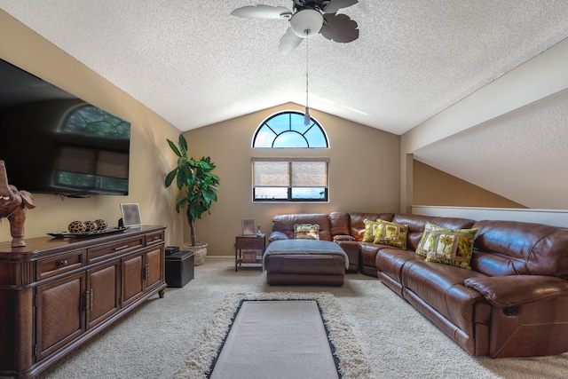 carpeted living room with ceiling fan, vaulted ceiling, and a textured ceiling