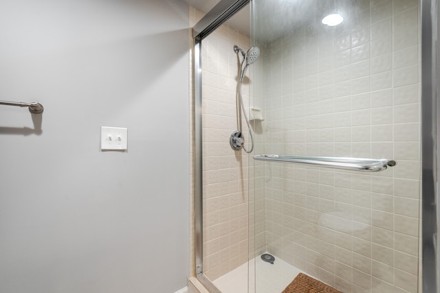 bathroom featuring a shower with door