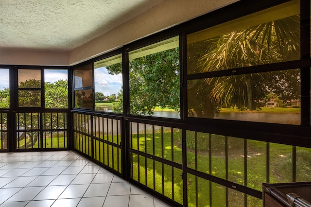 unfurnished sunroom with a water view