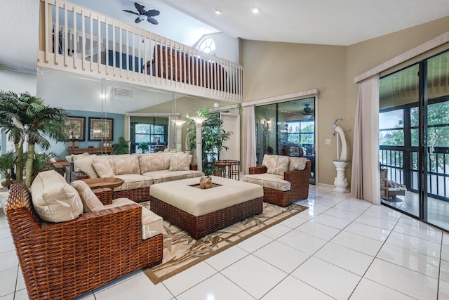 living room with a textured ceiling, ceiling fan, light tile patterned floors, and high vaulted ceiling