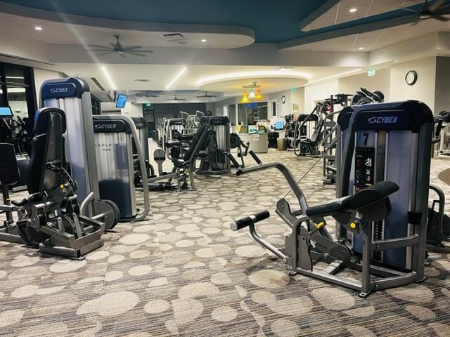 workout area with light colored carpet and ceiling fan