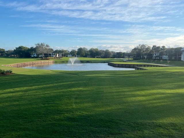 view of community featuring a yard and a water view