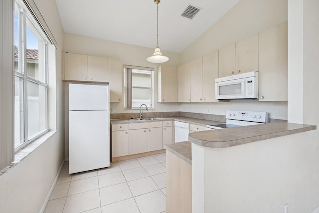 kitchen with white appliances, sink, kitchen peninsula, and decorative light fixtures