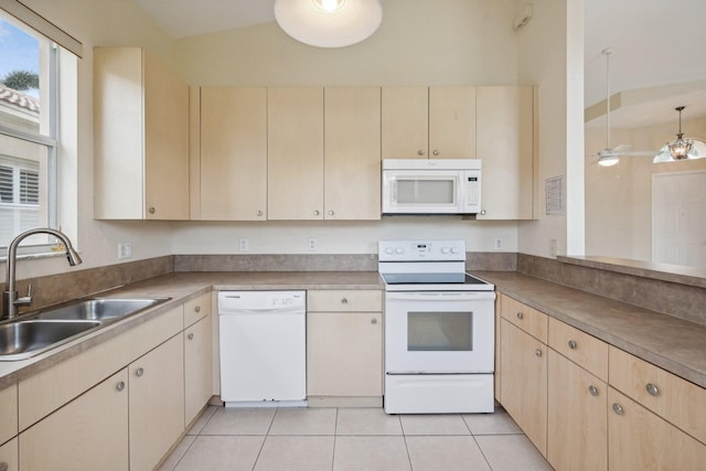 kitchen with white appliances, light tile patterned flooring, lofted ceiling, light brown cabinetry, and sink