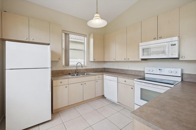 kitchen featuring white appliances, sink, hanging light fixtures, and light tile patterned floors