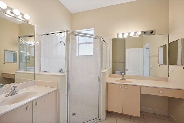 bathroom featuring double sink vanity, tile patterned flooring, and an enclosed shower