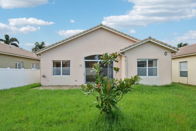 back of property featuring a lawn