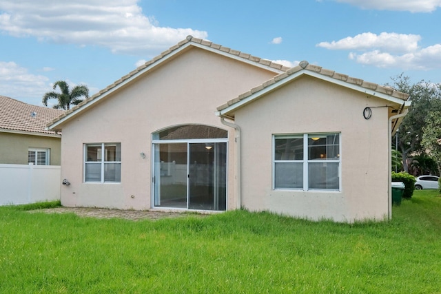 back of property featuring a lawn