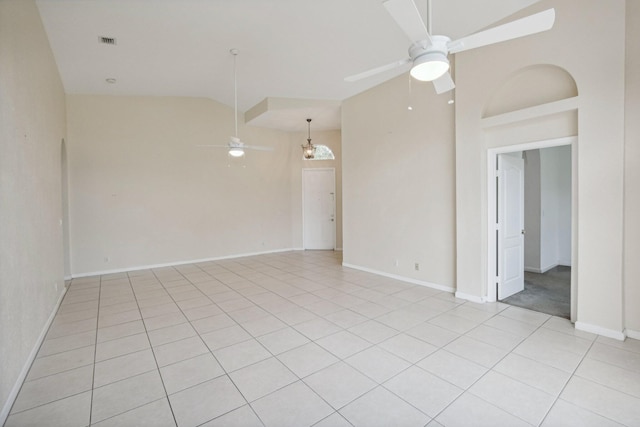 spare room with ceiling fan, high vaulted ceiling, and light tile patterned floors