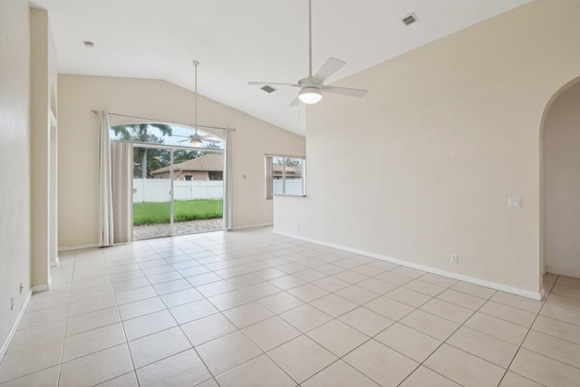 spare room featuring ceiling fan, lofted ceiling, and light tile patterned floors