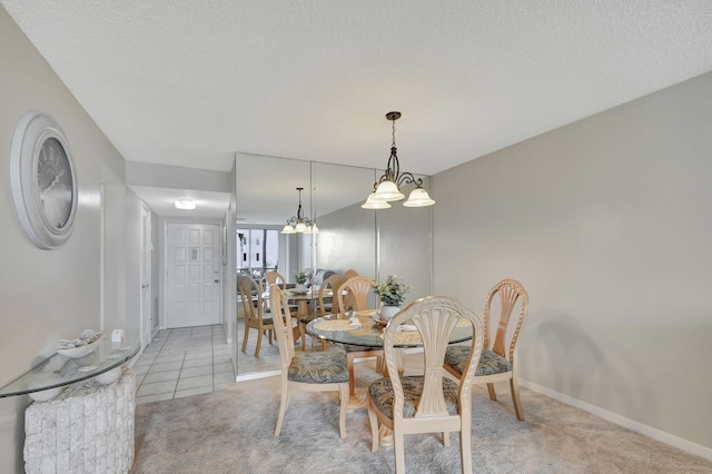 carpeted dining area featuring a textured ceiling and a notable chandelier