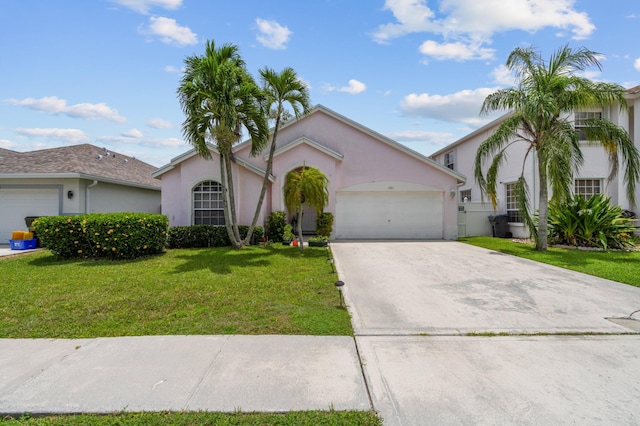 view of front of house featuring a front yard and a garage