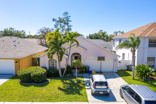 view of front facade with a garage and a front lawn