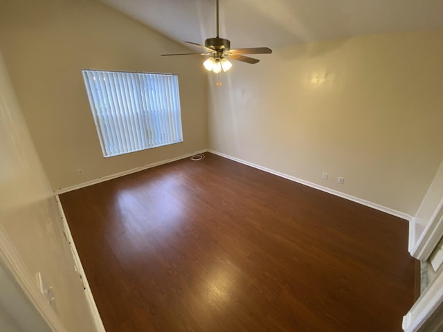 spare room with ceiling fan, dark wood-type flooring, and lofted ceiling