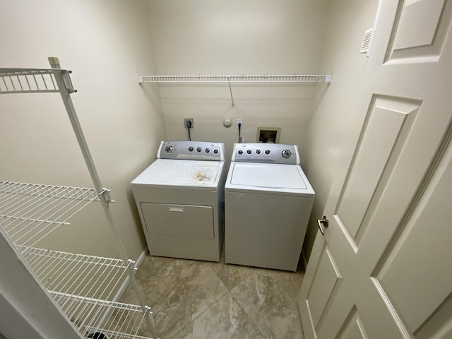 clothes washing area featuring separate washer and dryer