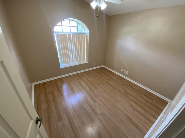 empty room with vaulted ceiling, light hardwood / wood-style floors, and ceiling fan