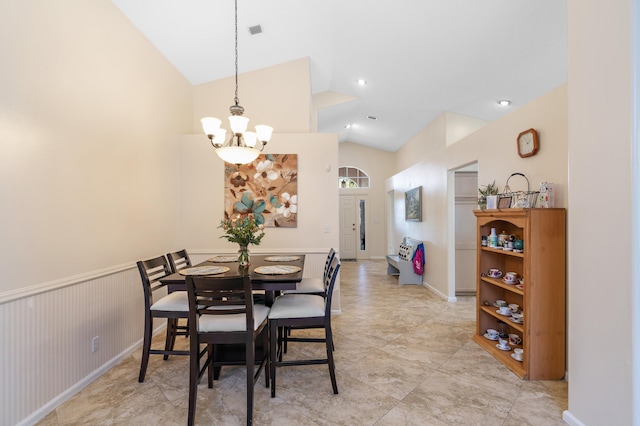 dining space featuring lofted ceiling and a chandelier