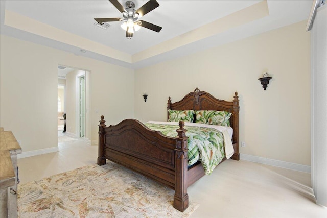 bedroom featuring a tray ceiling and ceiling fan