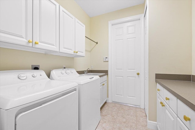 laundry area featuring cabinets, washing machine and dryer, sink, and light tile patterned flooring