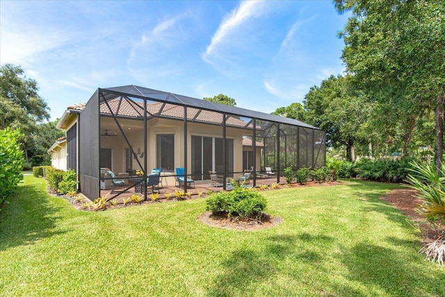 back of house with a patio, a lanai, and a lawn