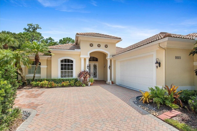 mediterranean / spanish house with a garage