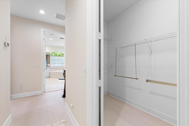 walk in closet featuring light wood-type flooring