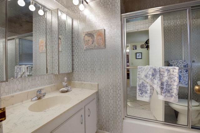 full bathroom with toilet, combined bath / shower with glass door, and vanity