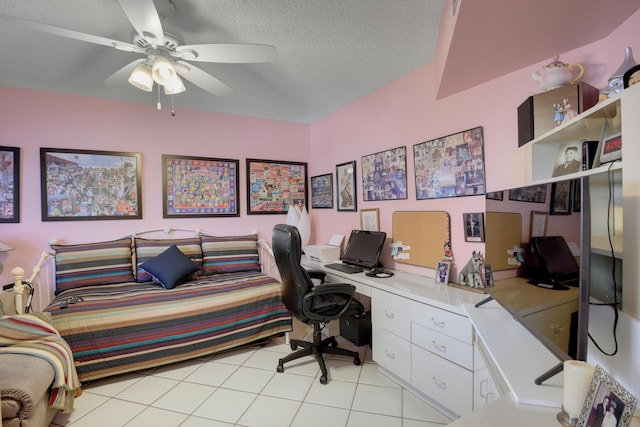 office space featuring ceiling fan, light tile patterned floors, and a textured ceiling