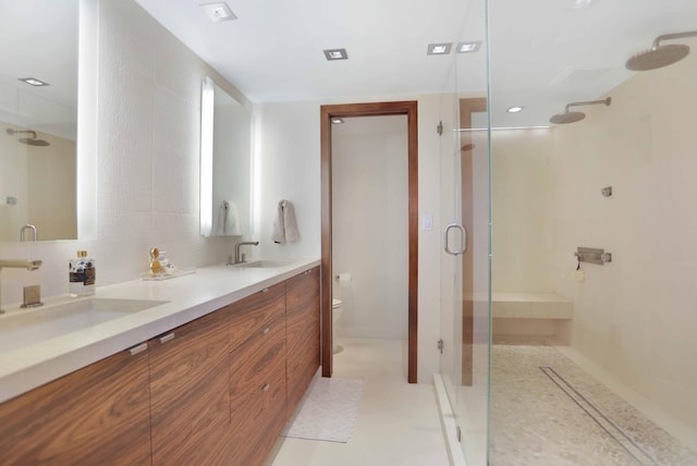 bathroom featuring tile patterned floors, vanity, a shower with shower door, and toilet