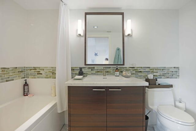 bathroom with vanity, toilet, and tasteful backsplash