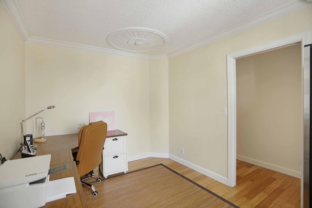 home office featuring hardwood / wood-style floors, a textured ceiling, and ornamental molding