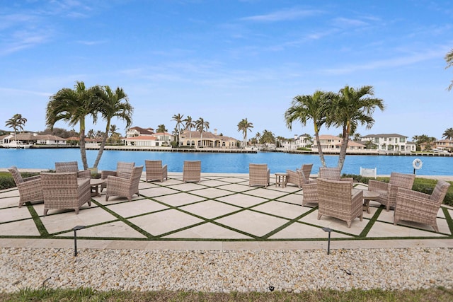 view of pool featuring a water view and a patio area