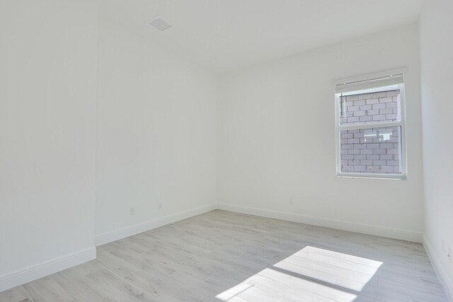 spare room featuring light wood-type flooring