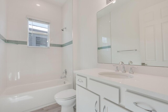 full bathroom featuring vanity, toilet, and tiled shower / bath combo