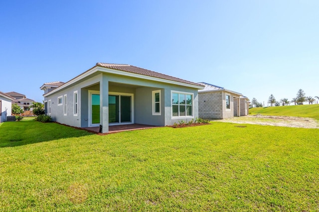 rear view of house with a yard