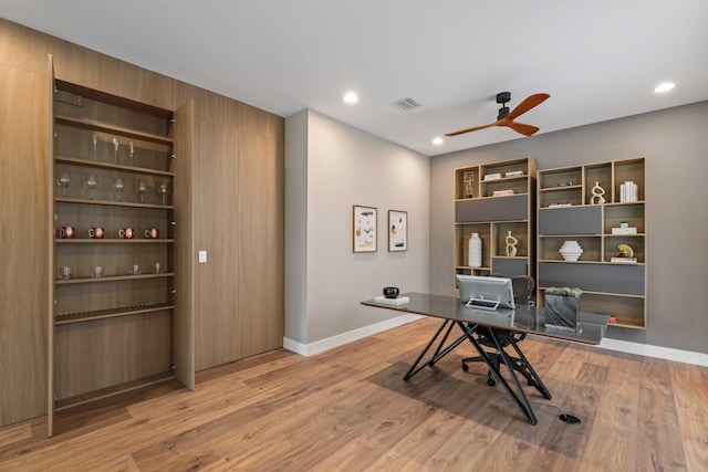 home office featuring hardwood / wood-style flooring and ceiling fan