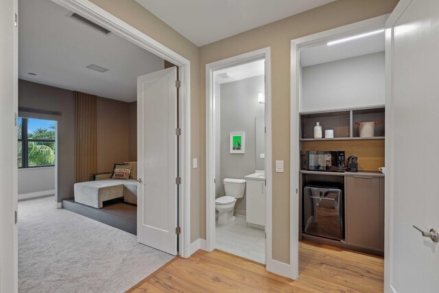 bathroom featuring wood-type flooring and toilet