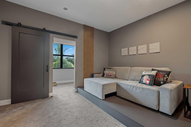 carpeted living room featuring a barn door