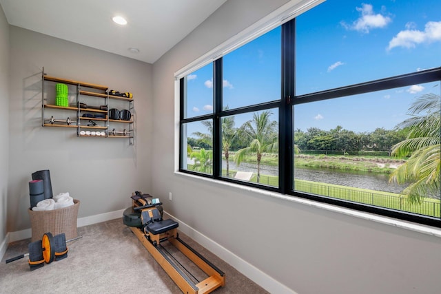 interior space featuring carpet flooring and a water view